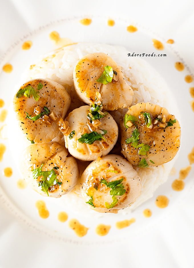 Easy and quick perfectly seared Portuguese Scallops with lemon, garlic and port wine reduction sauce recipe served with cooked rice. 