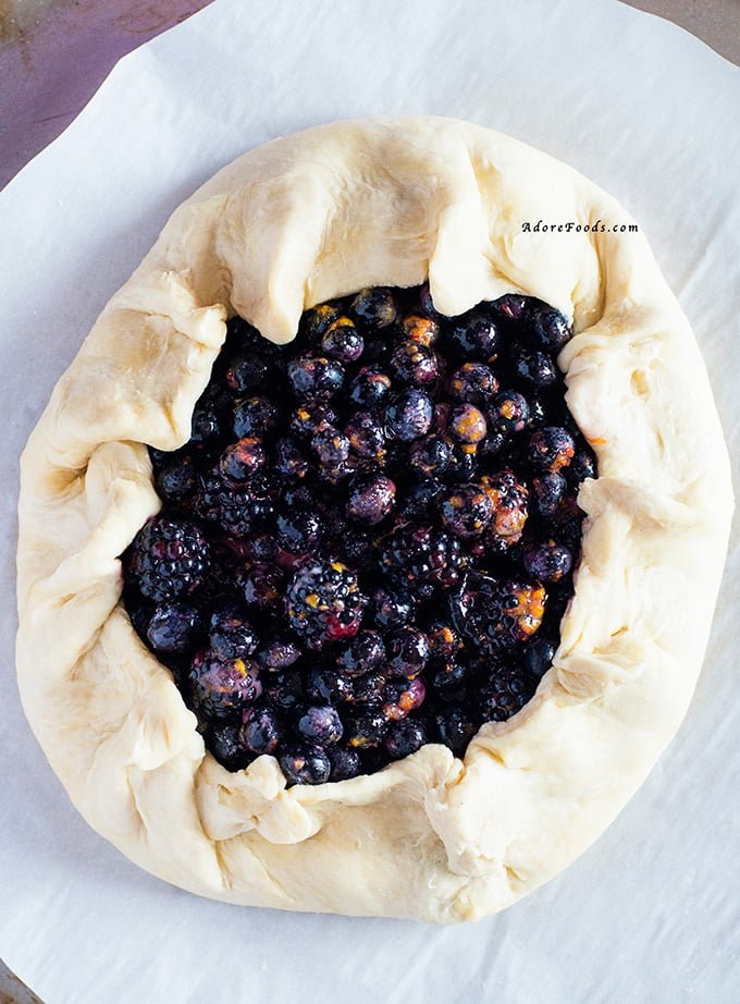 Delicious Rustic Berry Tart, packed with fragrant berry flavors in crispy, rough pastry served with vanilla custard!