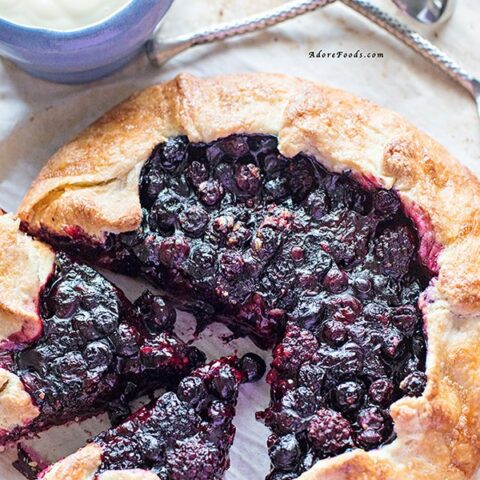 Delicious Rustic Berry Tart, packed with fragrant berry flavors in crispy, rough pastry served with vanilla custard!