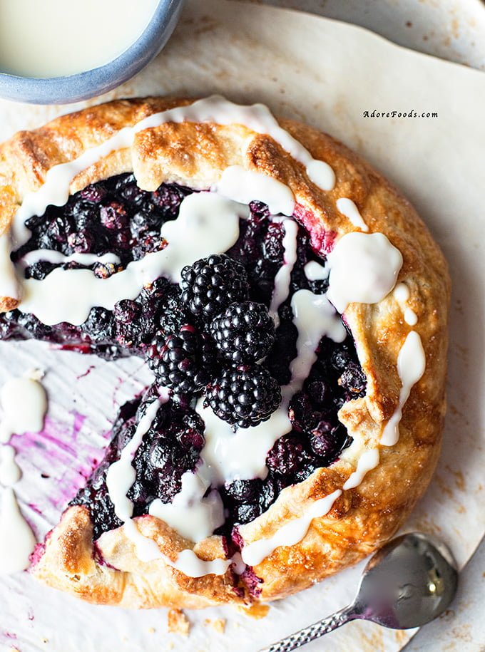 Delicious Rustic Berry Tart, packed with fragrant berry flavors in crispy, rough pastry served with vanilla custard!