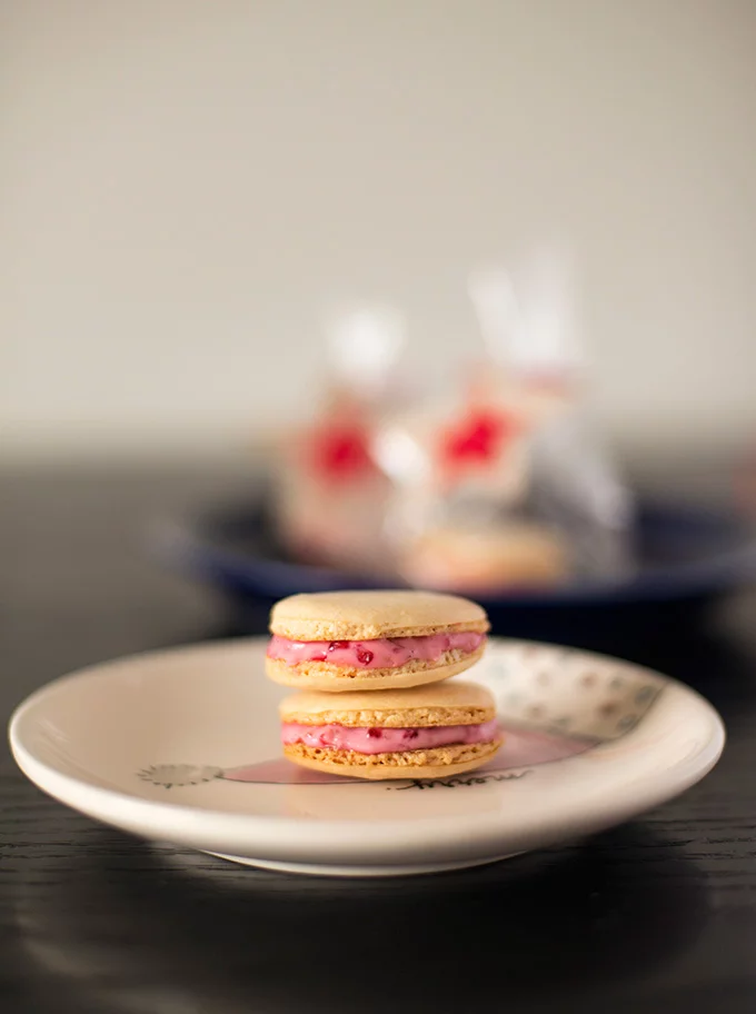 Orange macarons with white chocolate raspberry ganache