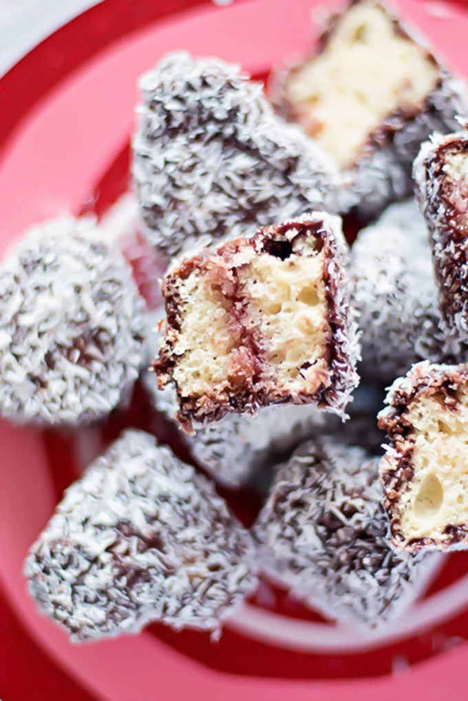 Mini Lamingtons on a red plate ready to be served