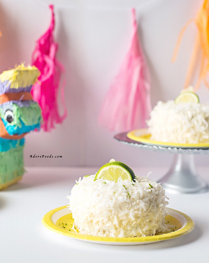 Delicious and easy Pina Colada cake recipe for Cinco de Mayo. Moist coconut sponge, lime curd and pineapple buttercream and shredded coconut flakes. 