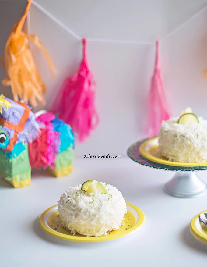 Delicious and easy Pina Colada cake recipe for Cinco de Mayo. Moist coconut sponge, lime curd and pineapple buttercream and shredded coconut flakes. 
