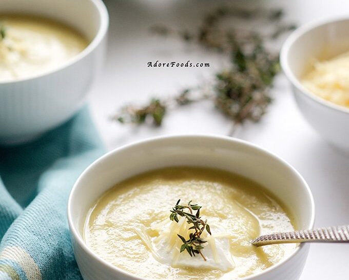 Perfect spring recipe! Creamy artichoke soup served with parmesan, sour cream and fresh thyme! In less than 30 minutes, you'll ladle this soup into your bowls!