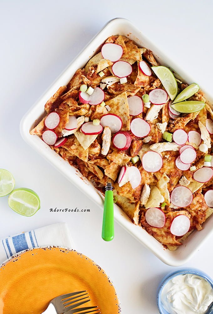 Chicken Chilaquiles - traditional Mexican style casserole is a mixture of tortilla chips, rich homemade red chile sauce and shredded chicken #mexican #cincodemayo