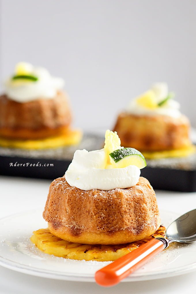 Moist pineapple and lime mini bundt cakes, served on rum and brown sugar grilled pineapple slices topped with whipped coconut cream