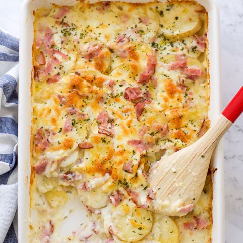 A tray with homemade scalloped potatoes with ham