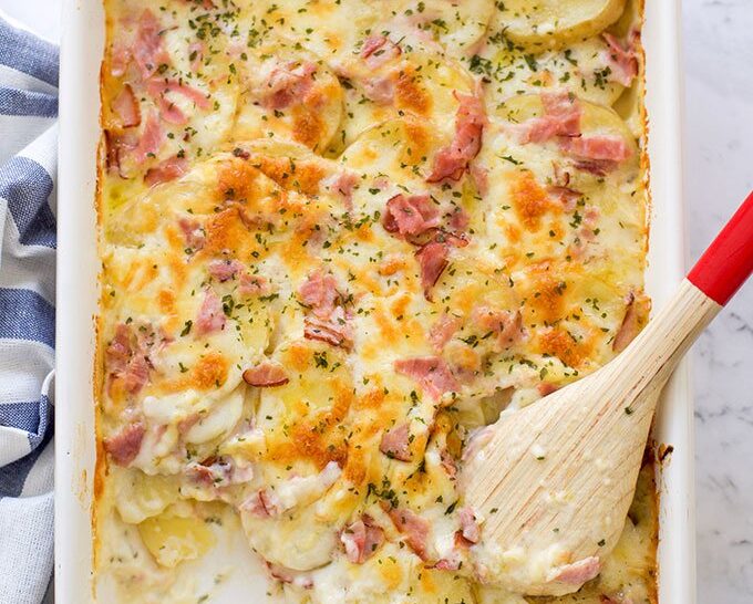 A tray with homemade scalloped potatoes with ham
