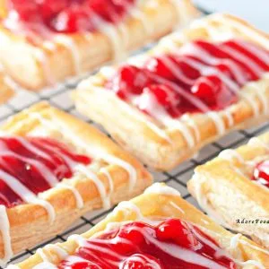 Indulge in the perfect blend of sweet cherries and creamy cheese with this Cherry Cream Cheese Danish recipe. Flaky, buttery pastry layers are filled with luscious cream cheese and topped with vibrant cherry preserves&mdash;ideal for breakfast, brunch, or a delightful dessert.