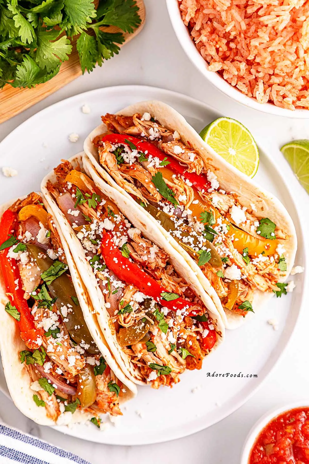 Easy Crockpot Chicken Fajitas made with juicy chicken, colorful bell peppers, and zesty fajita seasoning&mdash;perfect for a flavorful and effortless weeknight dinner! Just 10 minutes of prep and the slow cooker does the rest. Serve in tortillas, bowls, or over rice. Great for meal prep, family dinners, and Tex-Mex nights!